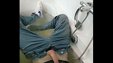 Joven twink se excita con polla dura en jeans mojados